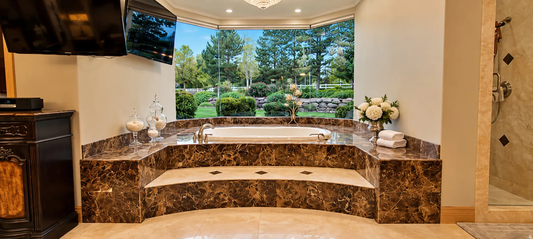 Built-in soaking tub with a brown marble-finish surround, large bay window, and light-toned tile flooring