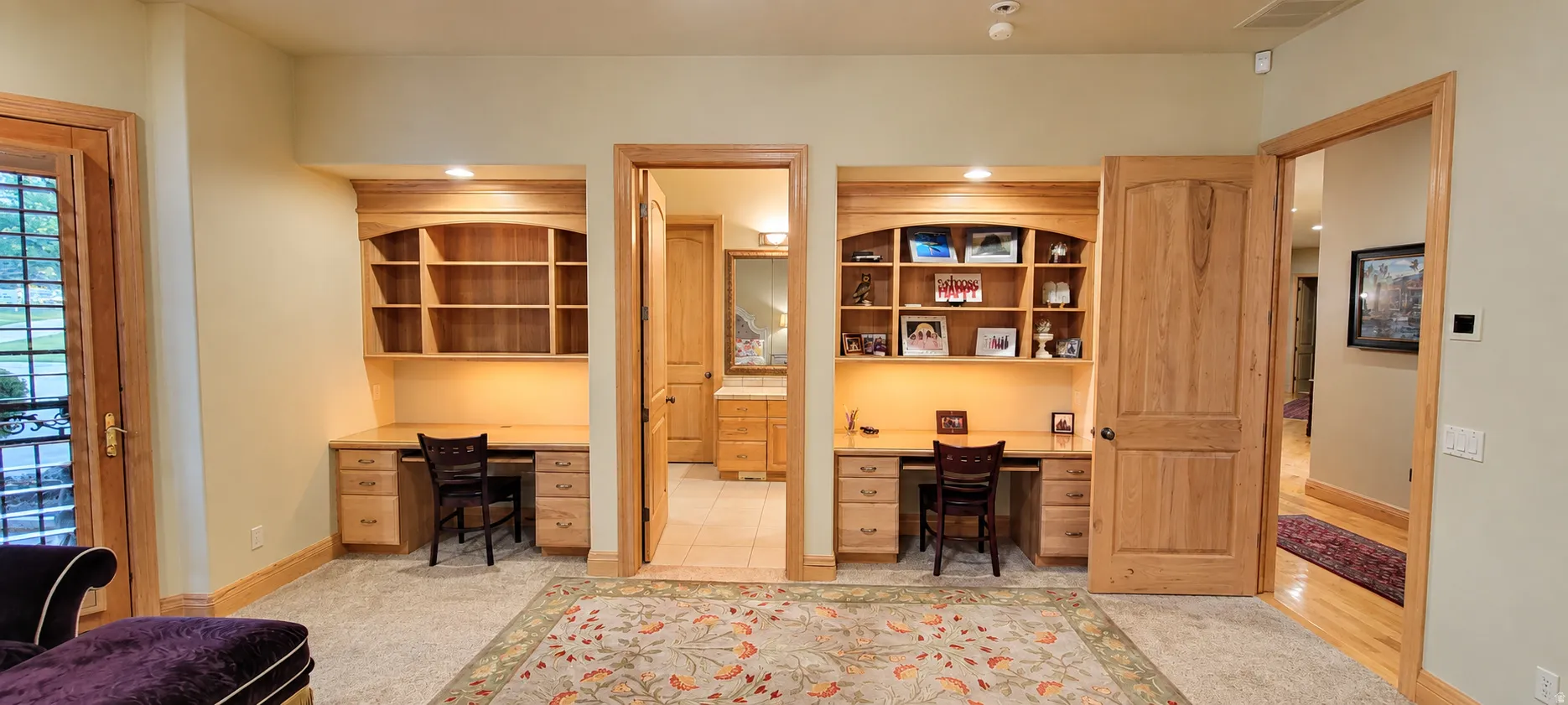 Dual built-in desk areas with integrated shelving and task lighting