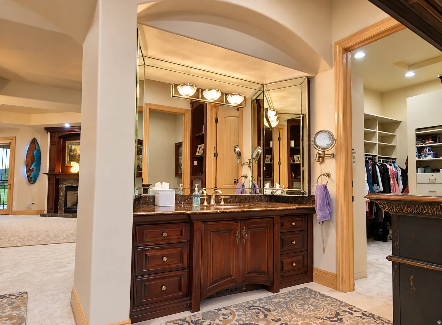 Double vanity with dark wood cabinetry and stone countertop