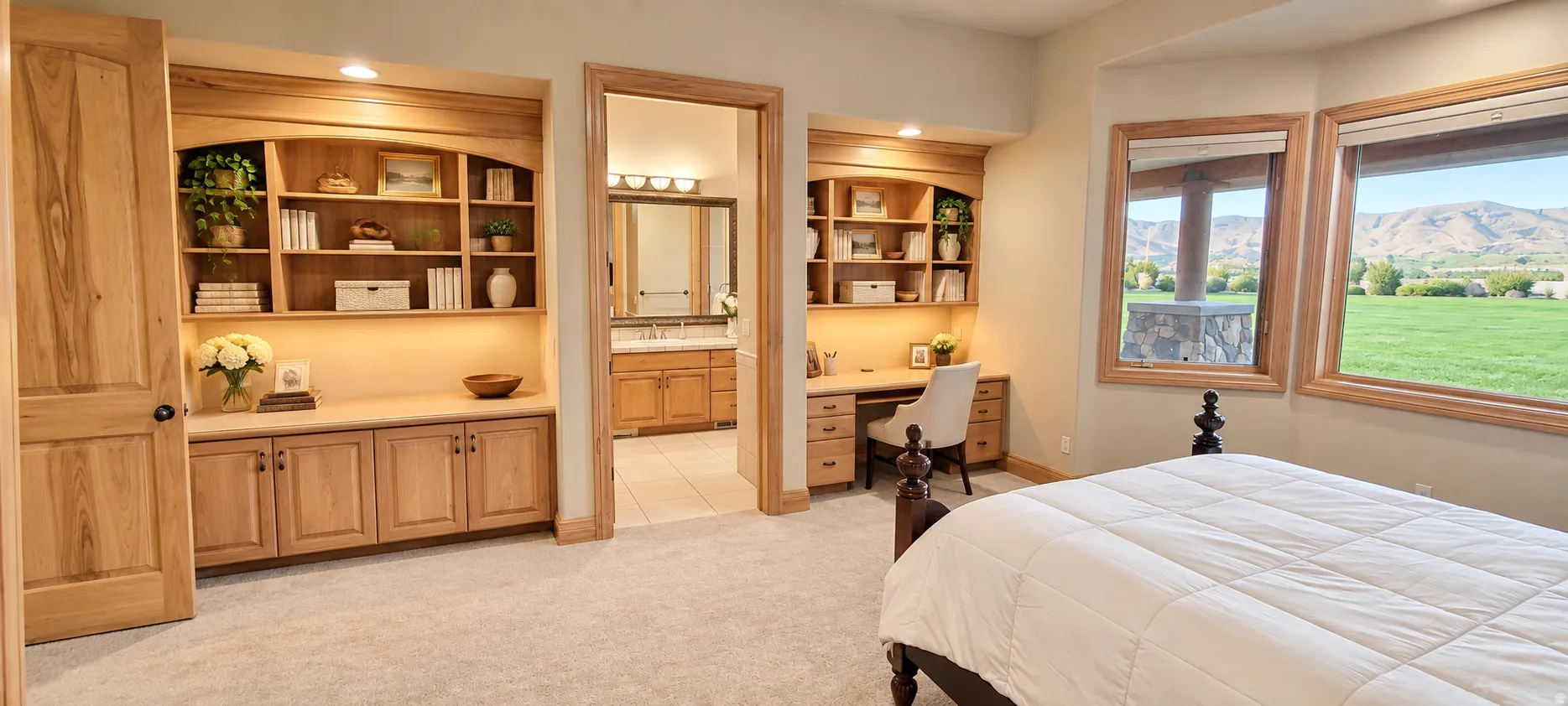 Built-in cabinetry with integrated shelving, dedicated desk space, recessed lighting, and expansive windows