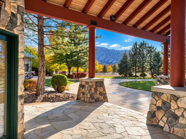 Stone veneer columns supporting a wood-beamed ceiling