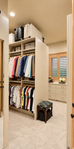 Built-in closet organization system with multiple hanging rods and shelving