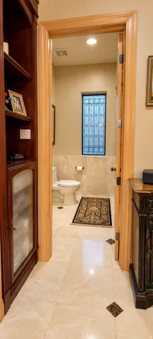 Built-in wood cabinetry, light-toned tile flooring with accent inserts, and wood door frames