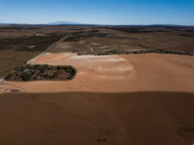 Aerial view of sparsely populated area with a mountain backdrop