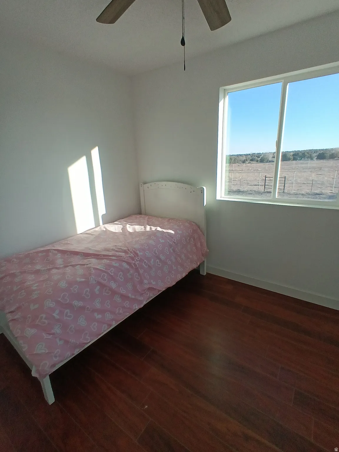 Bedroom with dark wood-type flooring and ceiling fan
