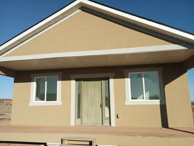 Back of house featuring stucco siding