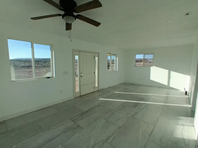 Spare room featuring baseboards and a ceiling fan
