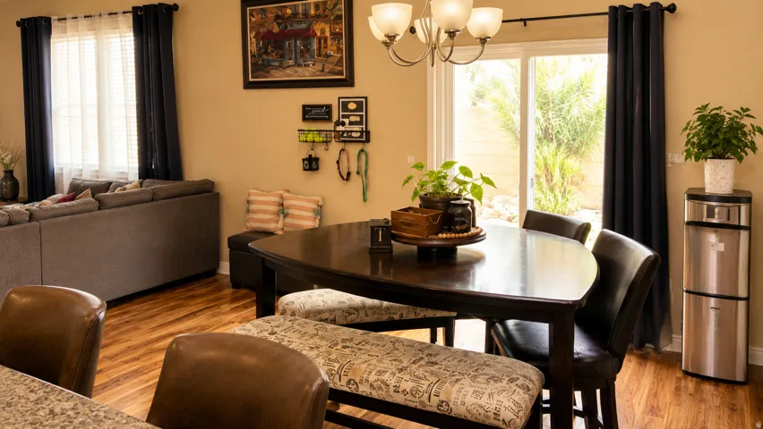 Open-concept living space featuring wood-finish flooring, a contemporary chandelier, and a sliding glass door providing outdoor access