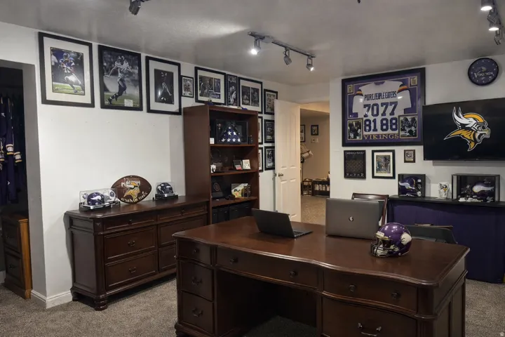 Office area featuring rail lighting and carpet