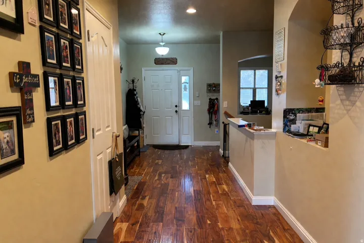 Entryway featuring wood-finish flooring, a solid panel front door, and a recessed ceiling light