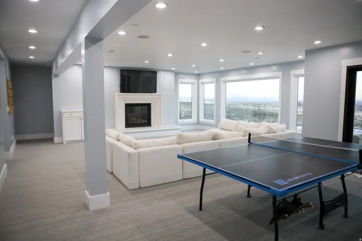 basement with a fireplace and floor to ceiling windows