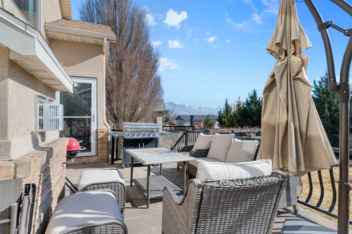 View of patio / terrace featuring an outdoor living space, a mountain view, and area for grilling