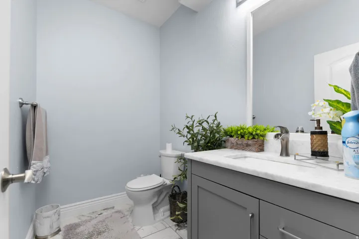 Bathroom featuring vanity and light marble finish floors
