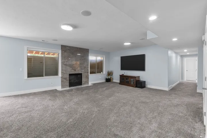 Unfurnished living room featuring carpet and a premium fireplace