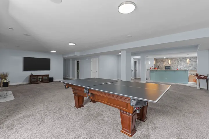 Game room featuring light carpet