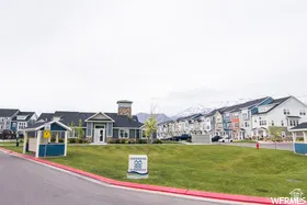 View of asphalt street with a residential view and curbs