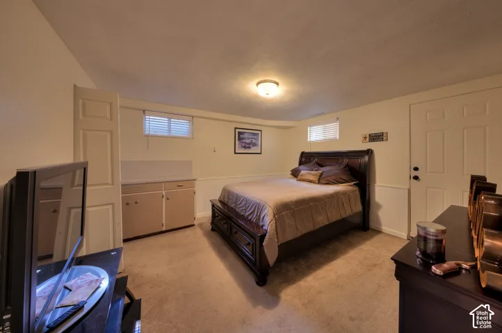 2nd Bedroom featuring light carpet and a wainscoted wall - roomy and spacious
