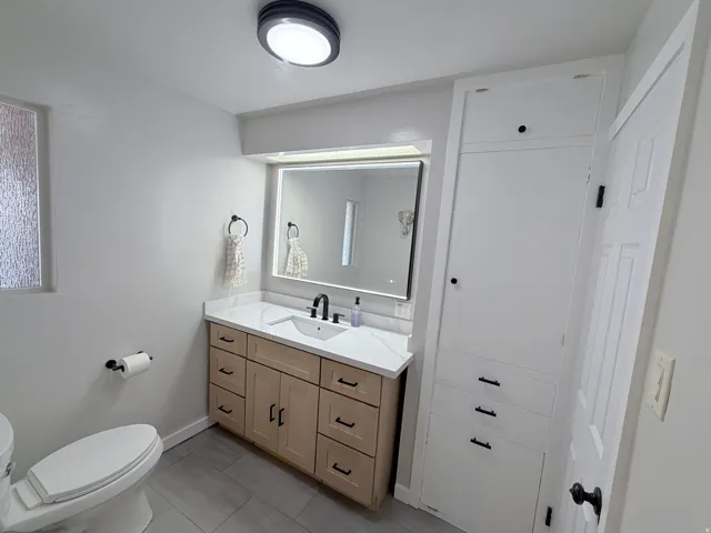 Bathroom with vanity and light tile patterned flooring