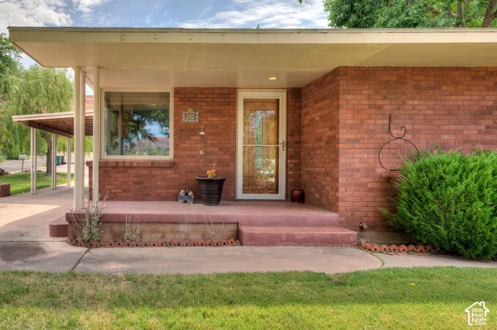 Mid-century modern brick house main entrance. Covered porch entry.