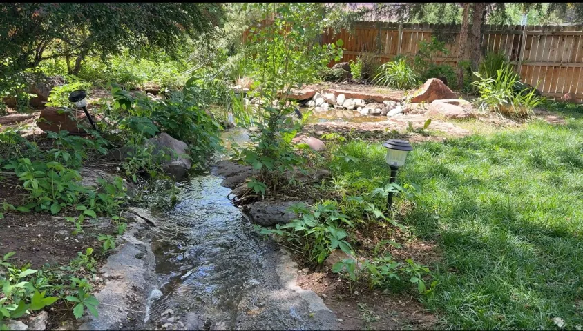 Gentle stream from the large pond to the lower, smaller one.