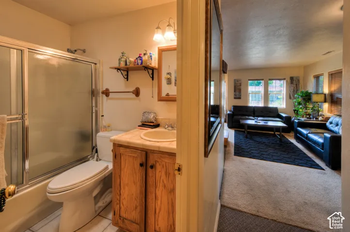 ADU Bathroom featuring vanity, enclosed tub / shower combo,