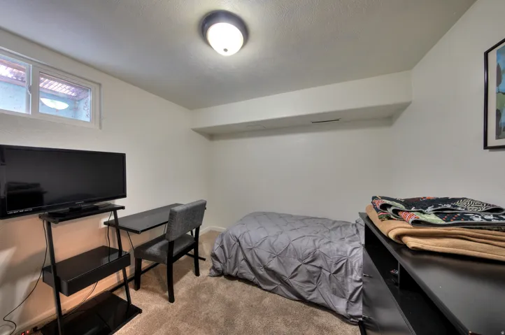 3rd Bedroom with light colored carpet and a textured ceiling