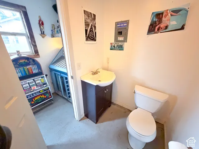 Half bath featuring vanity and toilet in GameDay Shed
