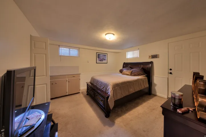 2nd Bedroom featuring light carpet and a wainscoted wall