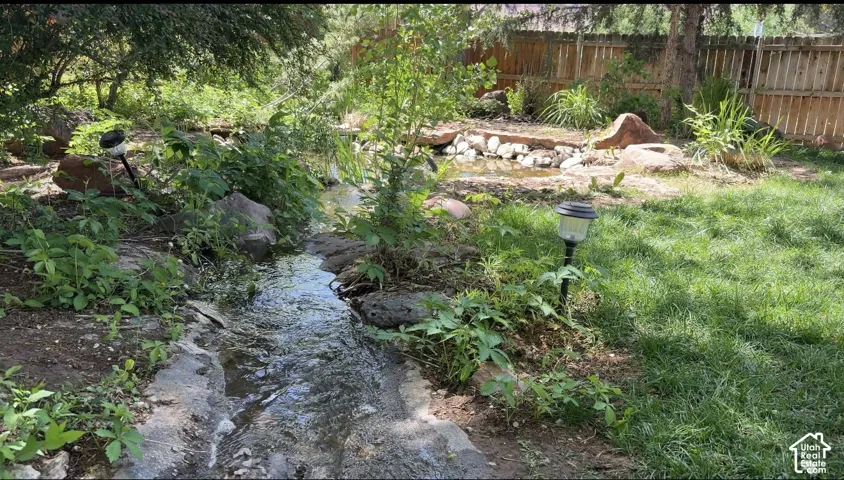Gentle stream from the large pond to the lower, smaller one.