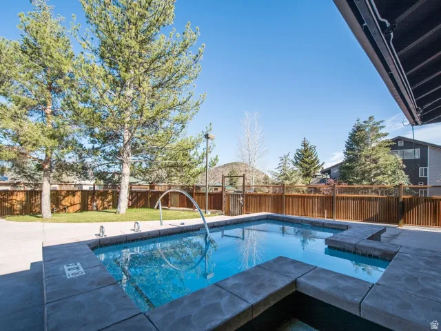 View of pool with a fenced backyard and patio surround