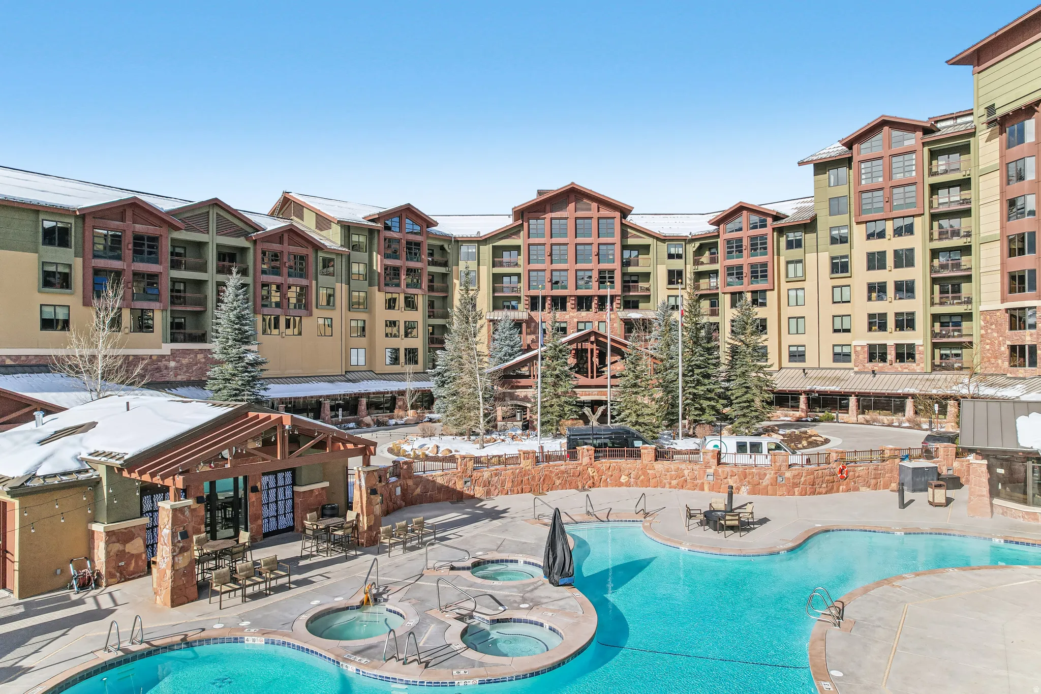 Community pool featuring a community hot tub and a patio area