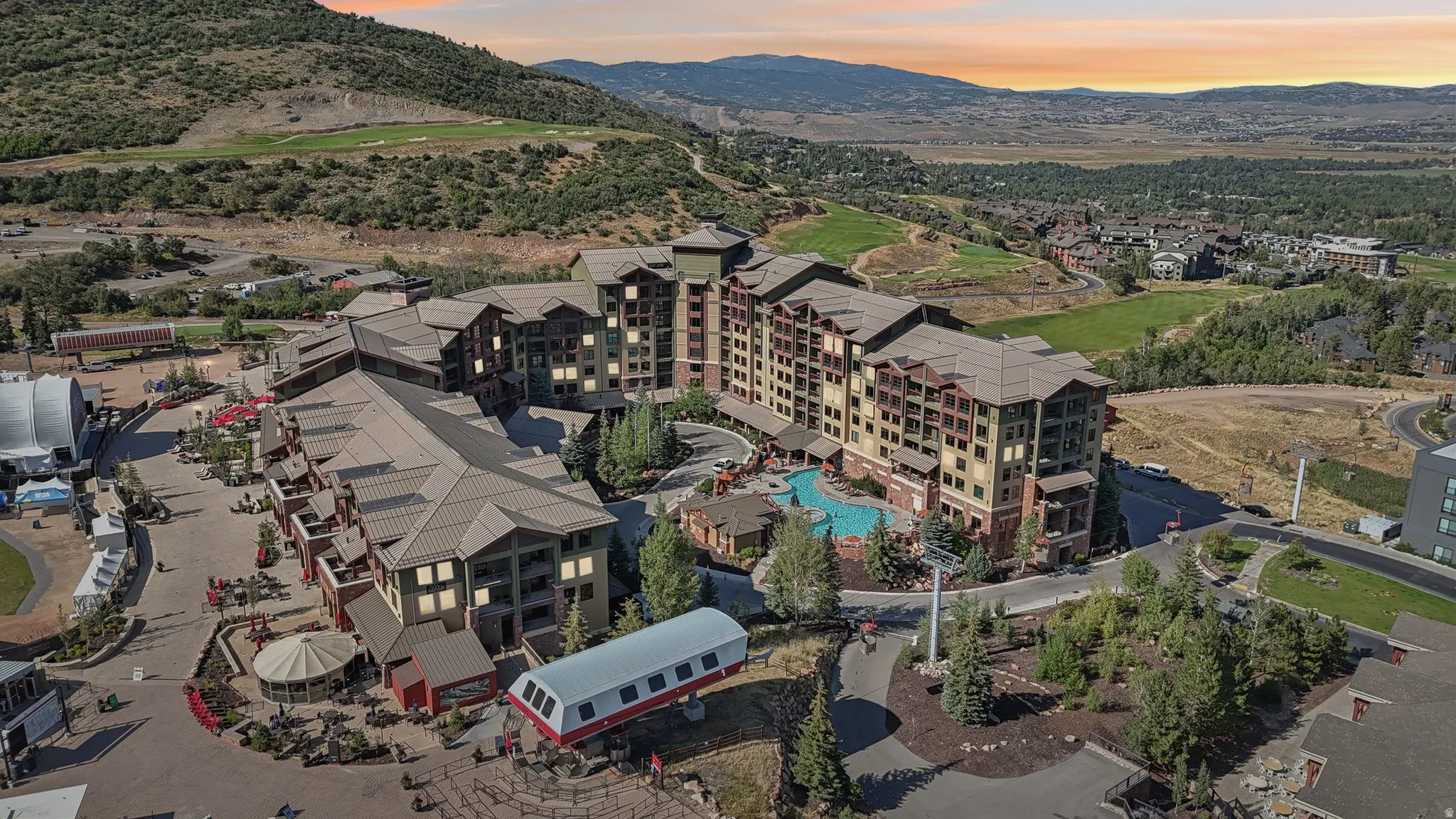 Aerial view of a mountainous background and a golf course