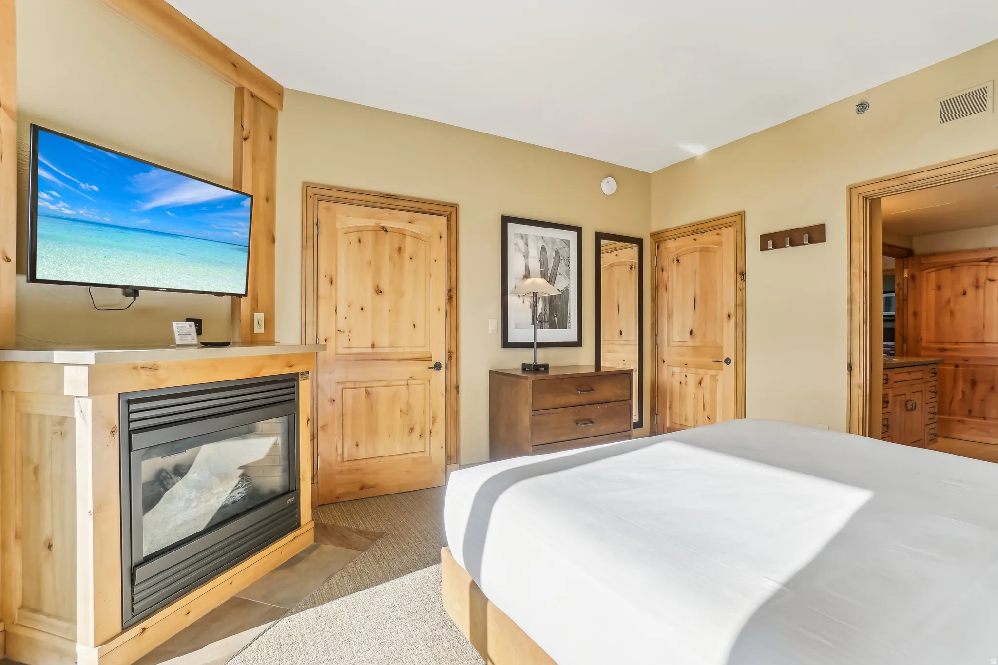 Bedroom with a glass covered fireplace