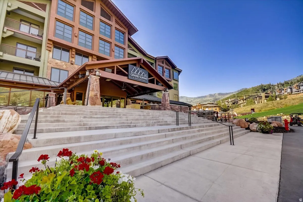 View of property's community with a patio and a mountain view