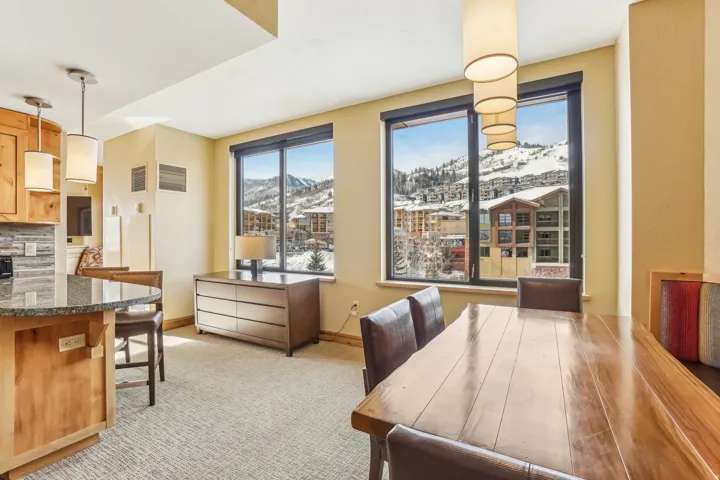 Dining room with a mountain view and light colored carpet