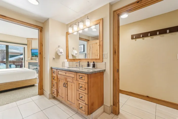 Bathroom with vanity, ensuite bath, and light tile patterned flooring