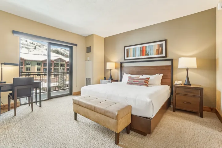 Carpeted bedroom with access to exterior and baseboards