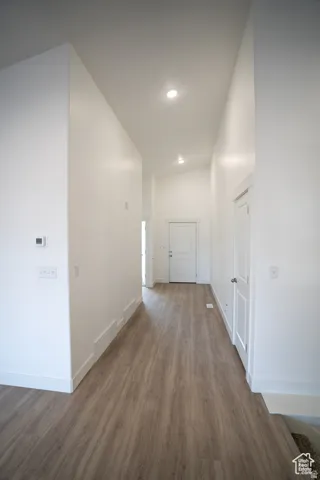 Hall featuring wood finished floors and baseboards