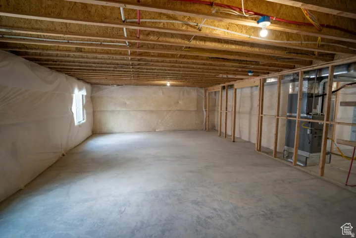 Basement featuring heating unit