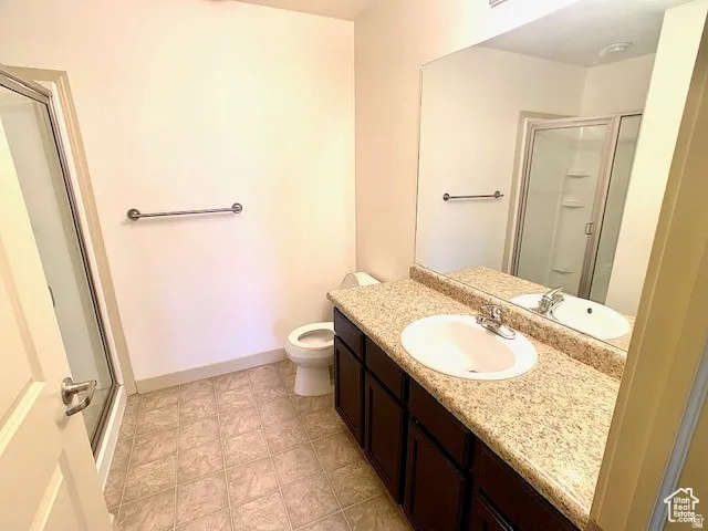 Full bathroom with a shower stall and vanity