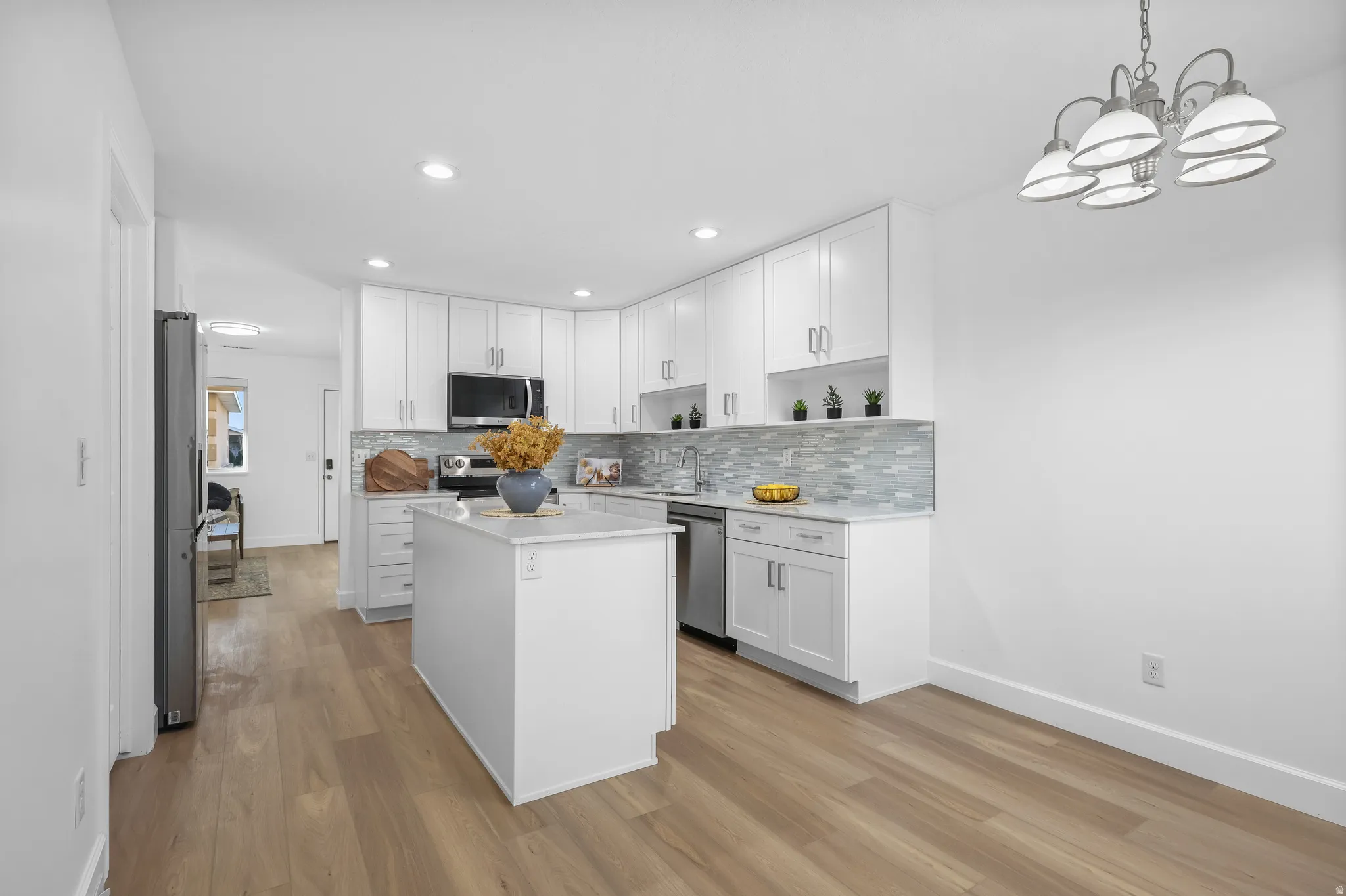 Kitchen featuring NEW soft close white cabinets, a NEW kitchen island, open shelves, and Luxury LPV Vinyl flooring