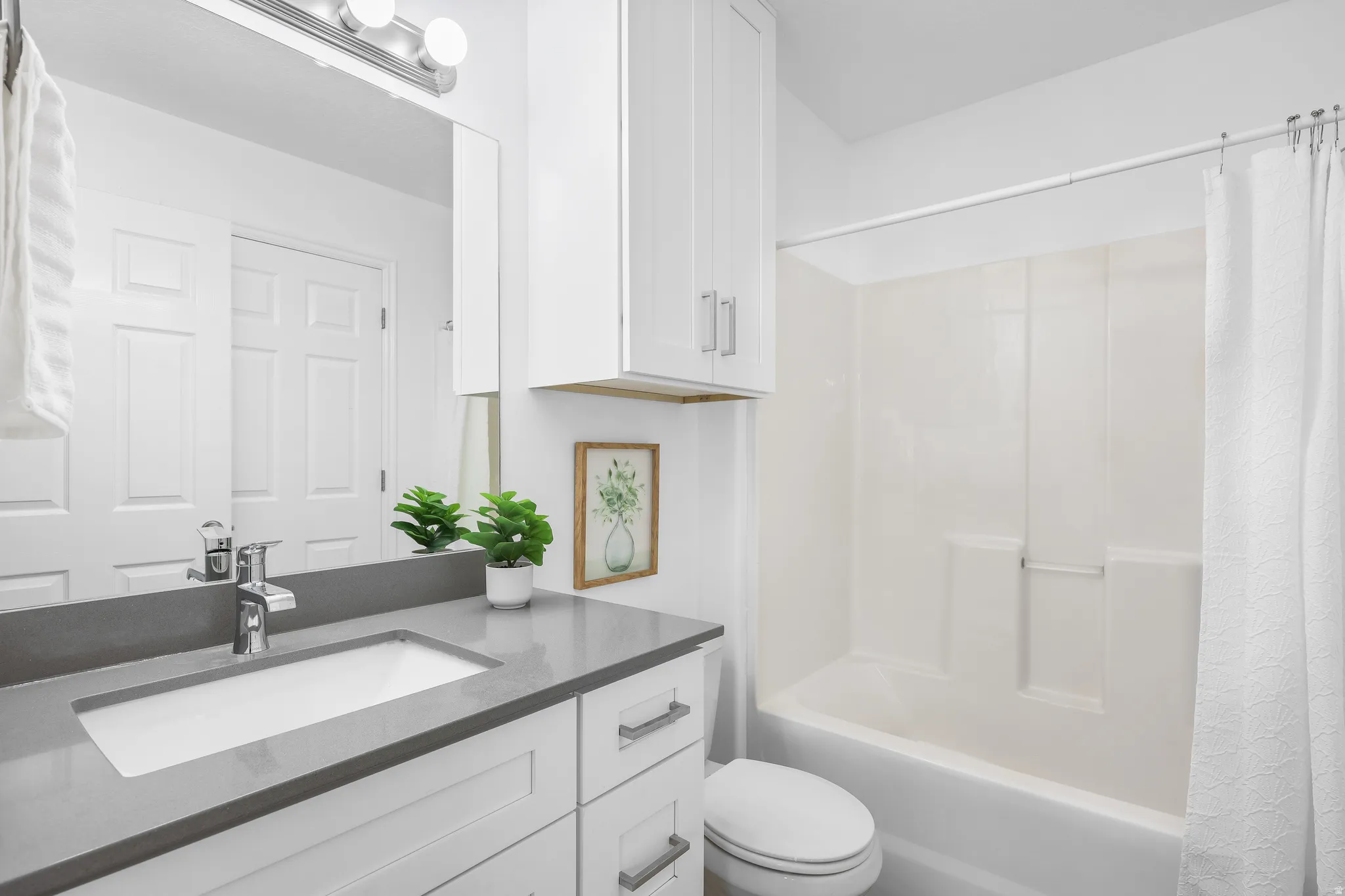 Full bathroom featuring a shower / bath combo with shower curtain, and a NEW vanity