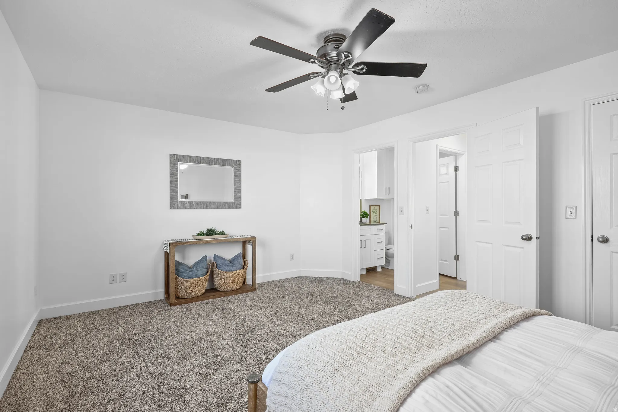 NEWLY carpeted bedroom with ceiling fan, ensuite bathroom, and a walk-in-closet