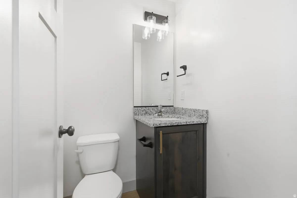 Half bathroom with vanity and toilet