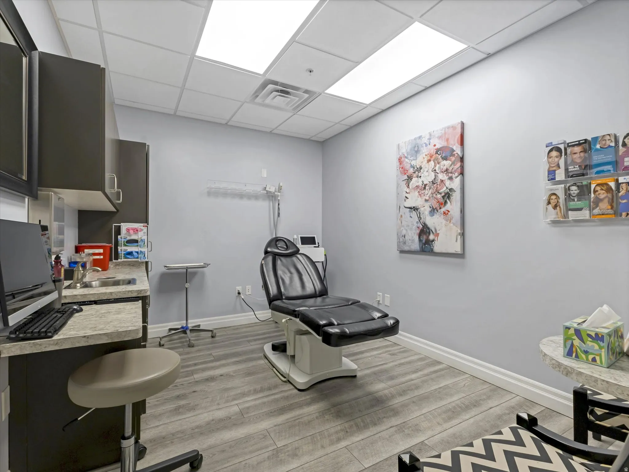 Misc room featuring a drop ceiling and a sink