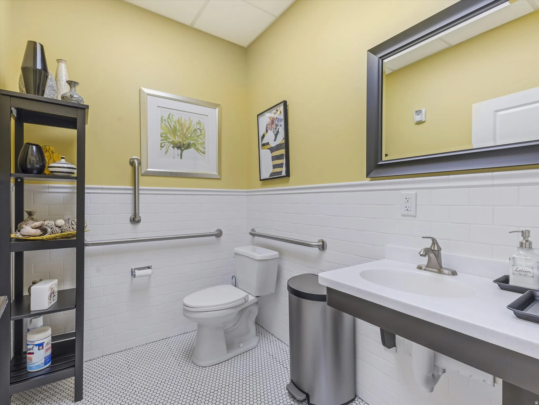 Bathroom featuring a wainscoted wall, tile walls, and tile patterned floors
