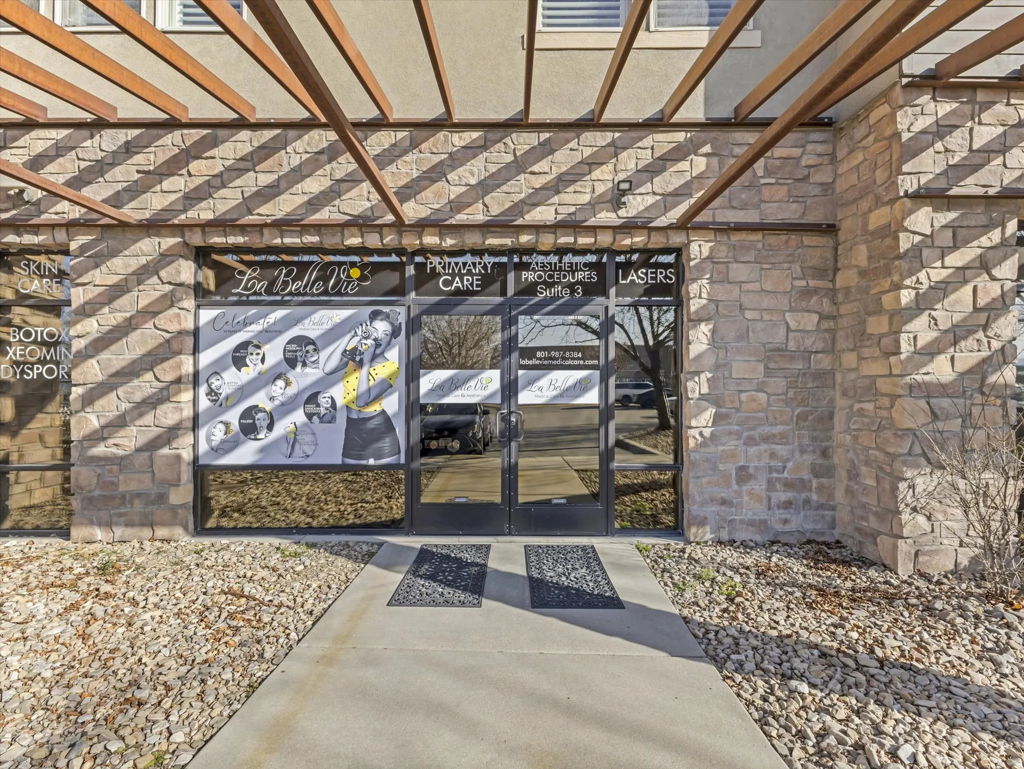 View of exterior entry featuring french doors and a pergola