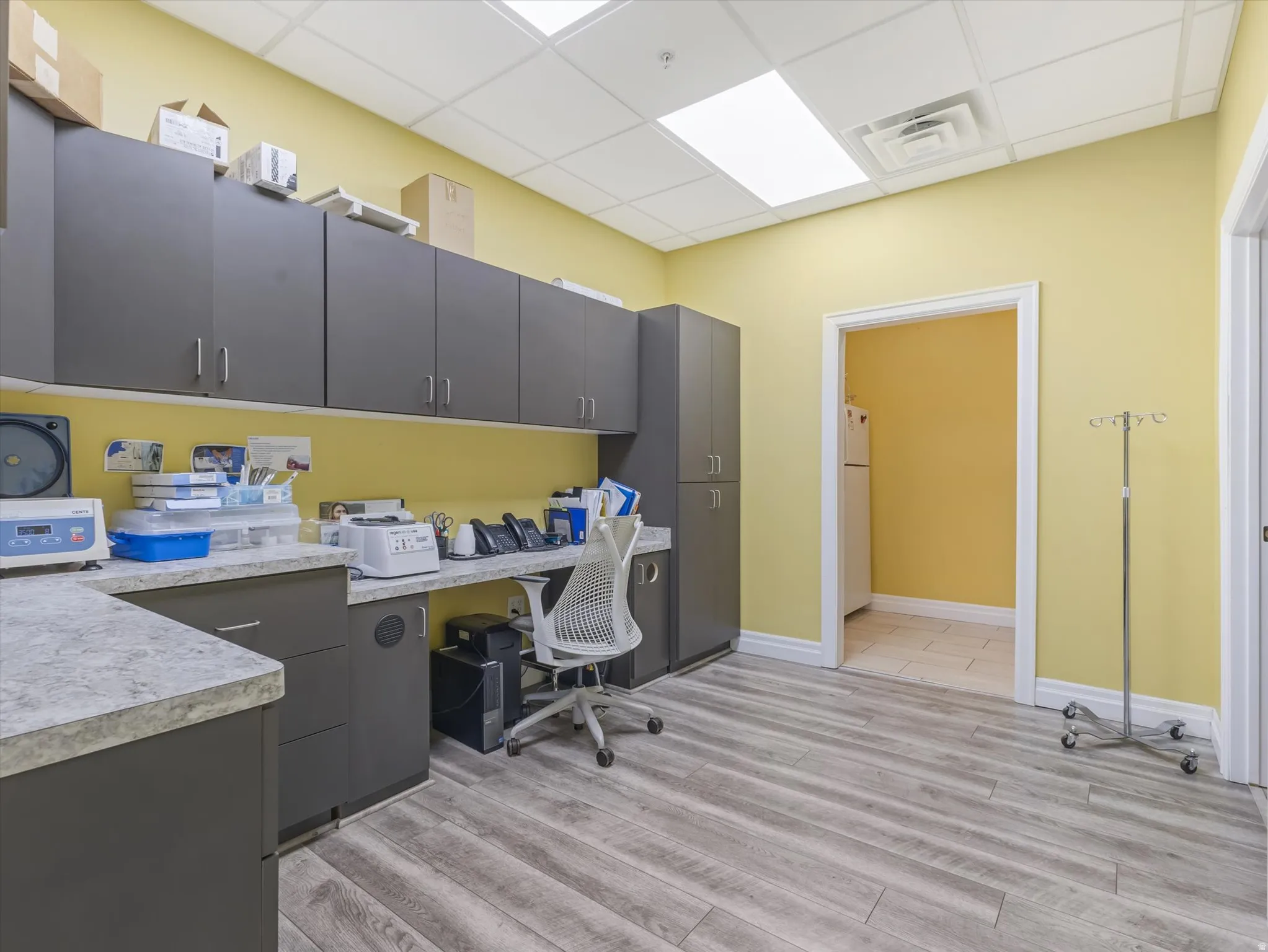 Office featuring a paneled ceiling and built in desk