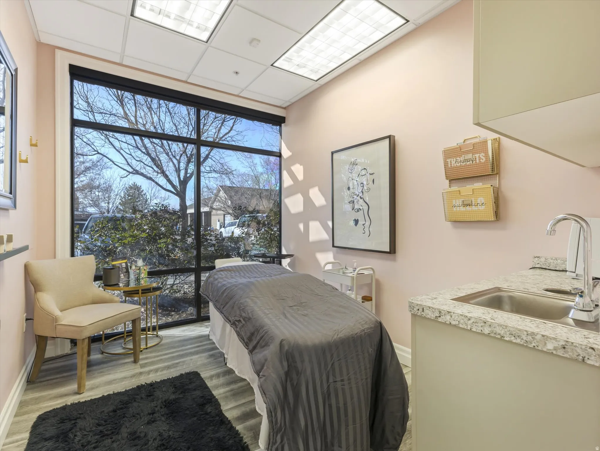 Bedroom featuring floor to ceiling windows, a paneled ceiling, and light wood-style flooring