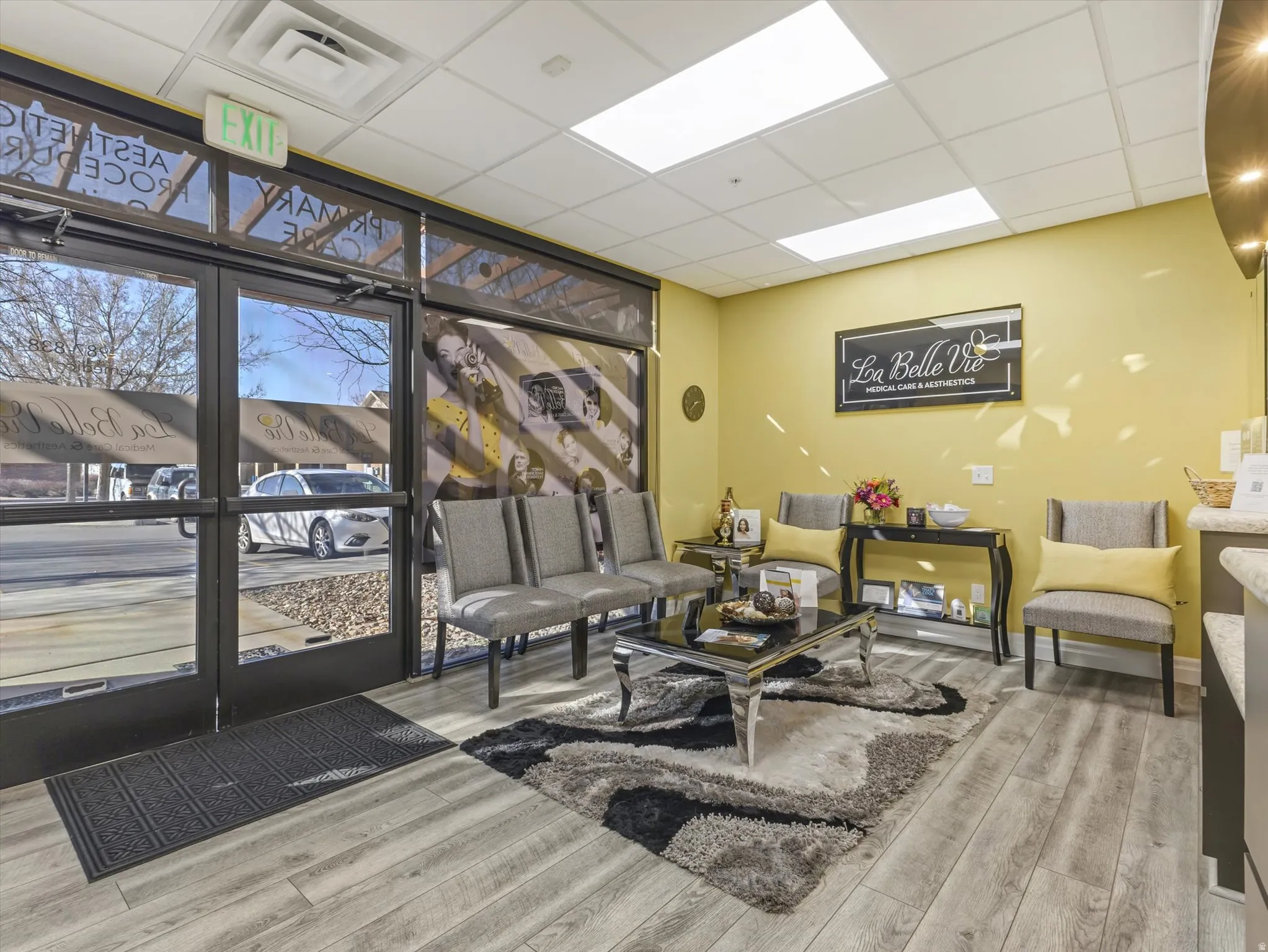 Common area featuring floor to ceiling windows and a paneled ceiling